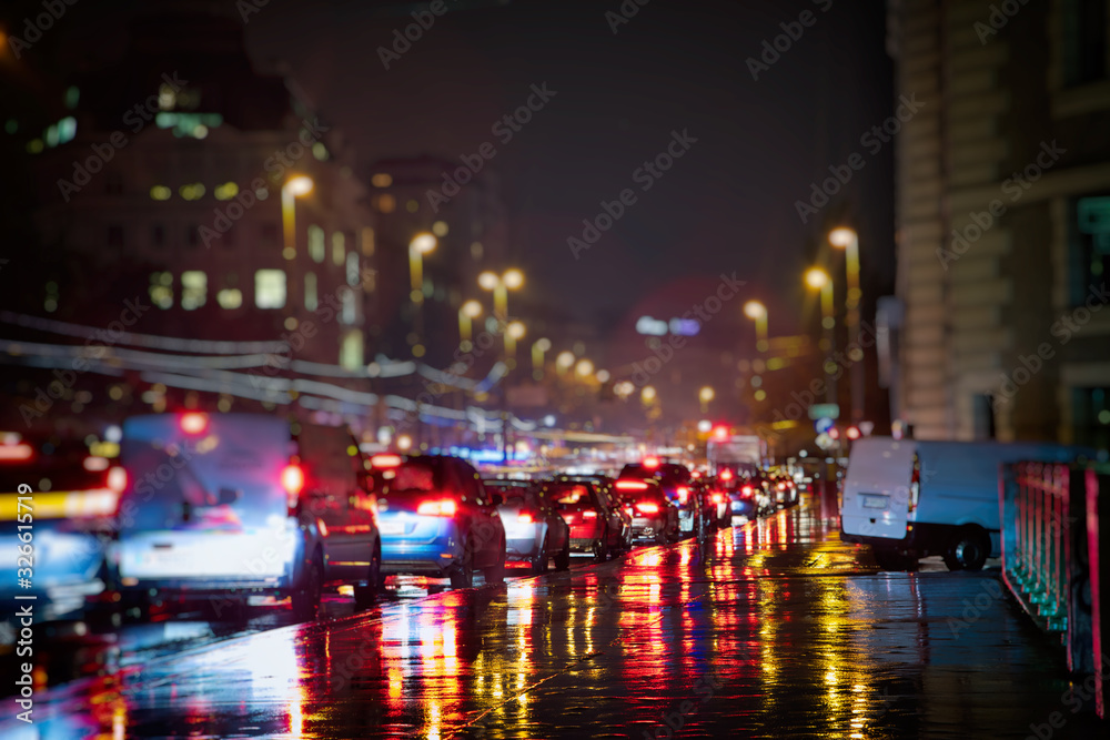 busy traffic in the city on rainy night