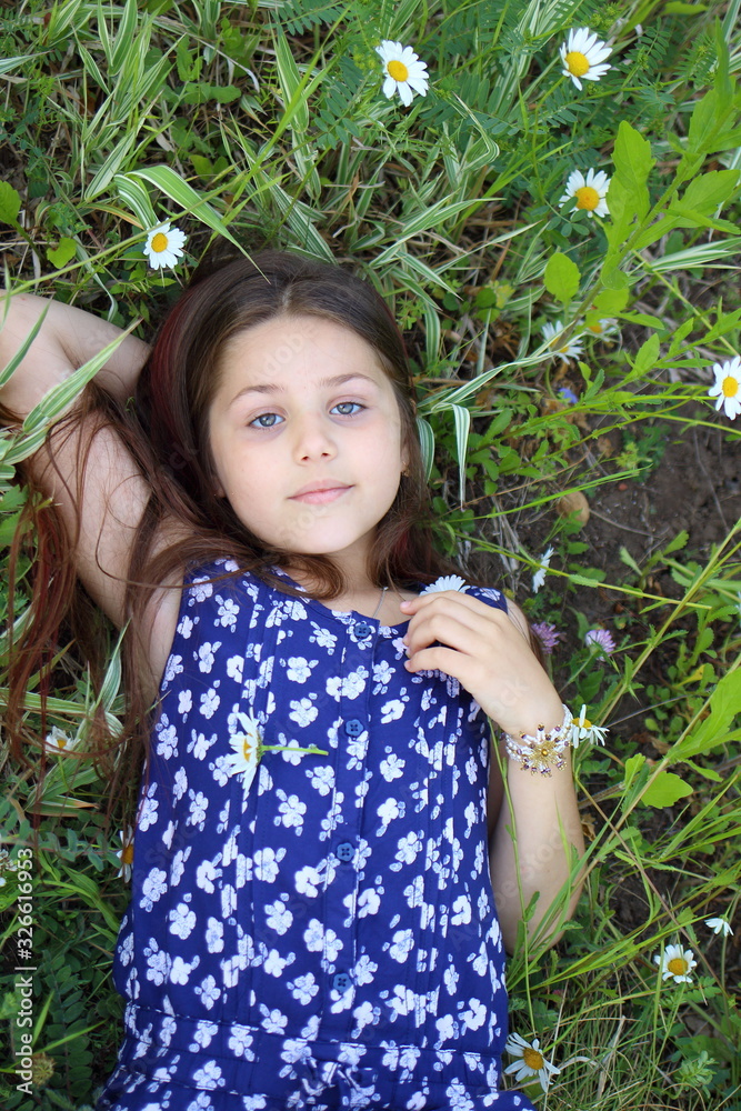 Girl with camomiles. Beautiful concept of a summer landscape. Summer and vacation. Parks and recreation Girl with camomiles. Beautiful concept of a summer landscape. Summer and vacation. Parks and recreation