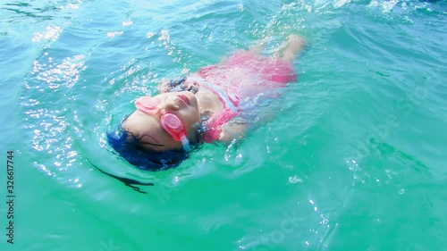 asian girl swimming backstroke