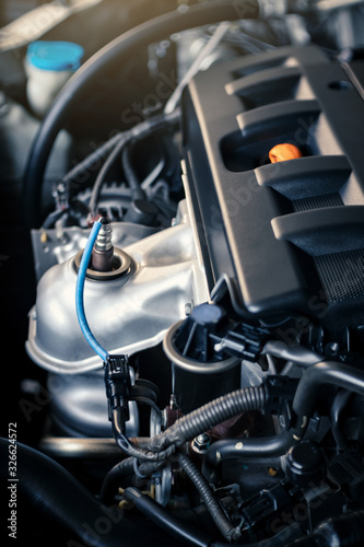 details of modern car engine with sunlight effect, shallow depth of field, internal combustion engine vehicle