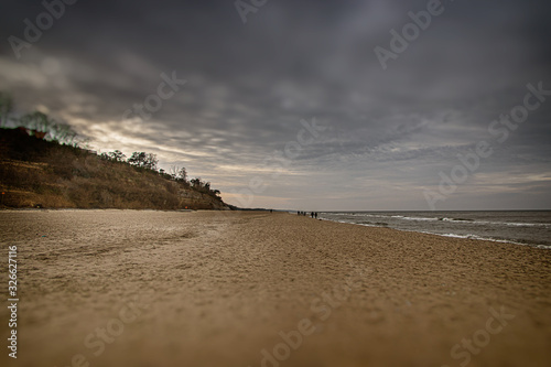 calm landscape of the beach on the Polish Baltic Sea on a cloudy February day photo