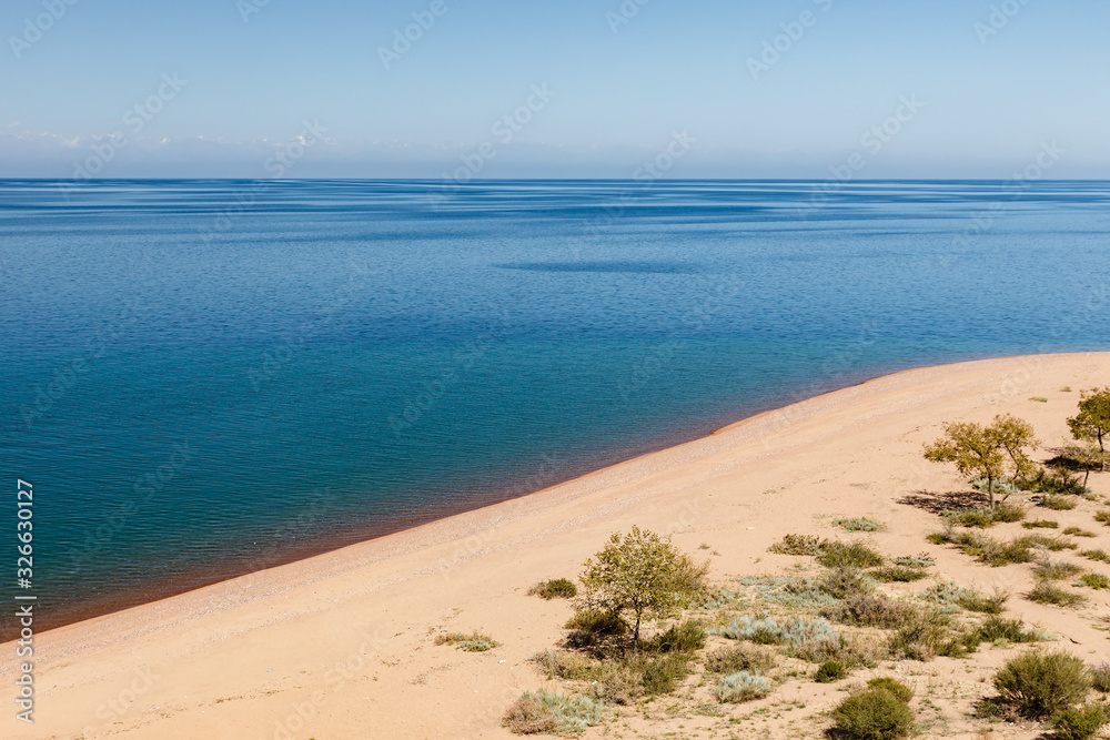 Lake Issyk-kul, Kyrgyzstan, empty sandy beach on the southern shore of the lake