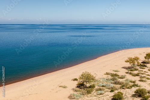 Lake Issyk-kul  Kyrgyzstan  empty sandy beach on the southern shore of the lake