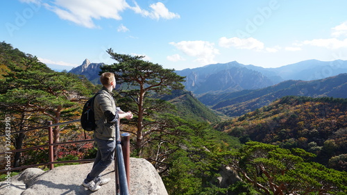 Young man on the top of Ulsanbawi mountain in a Seoraksan National Park in South Korea, Asia.