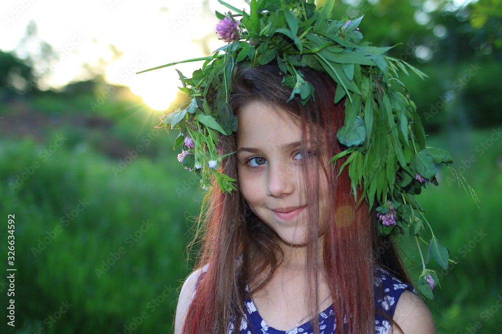 Cute Caucasian girl in a flower wreath walks at sunset in the park. The concept of summer and relaxation. Vacations and leisure for children. Nature and flowers.
Cute Caucasian girl in a flower wreath walks at sunset in the park. The concept of summer and relaxation. Vacations and leisure for children. Nature and flowers.