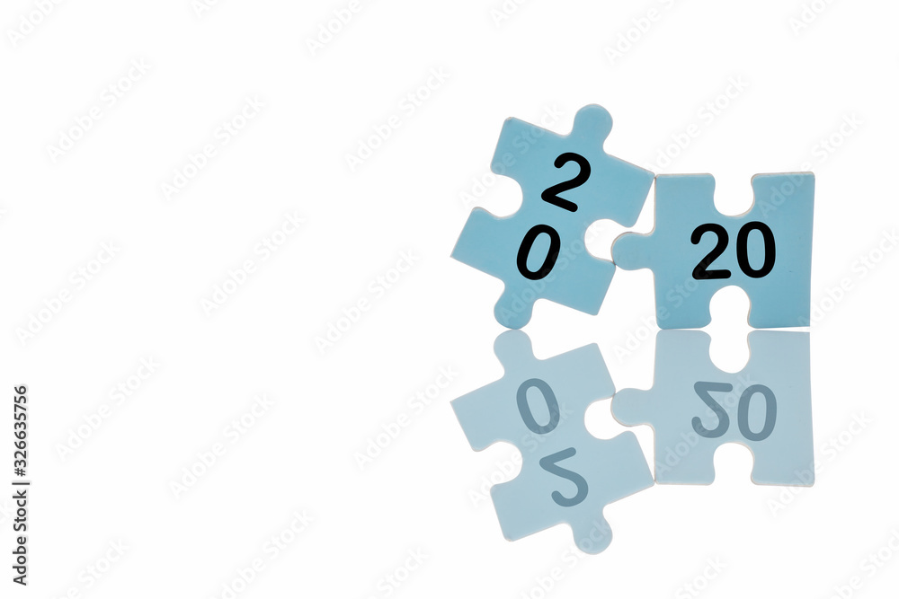 New year 2020 on blue puzzle with reflection on white background, business concept and success idea New year 2020 on blue puzzle with reflection on white background, business concept and success idea