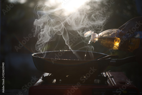 Cooking with smoke and sunset light background.