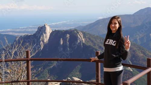 Young woman on the top of Ulsanbawi mountain in a Seoraksan National Park in South Korea, Asia.