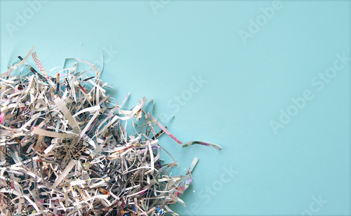 Shredded paper on light blue background. Selective focus image.