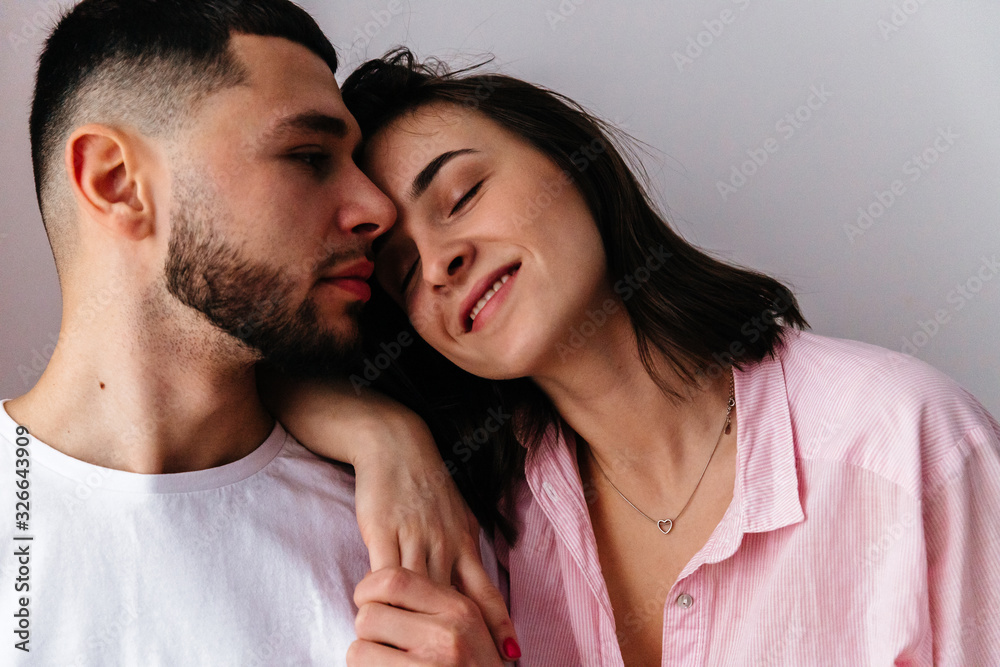 sexy couple at home. Woman in lingerie kissing, hugging and playing with her husband sexy couple at home. Woman in lingerie kissing, hugging and playing with her husband