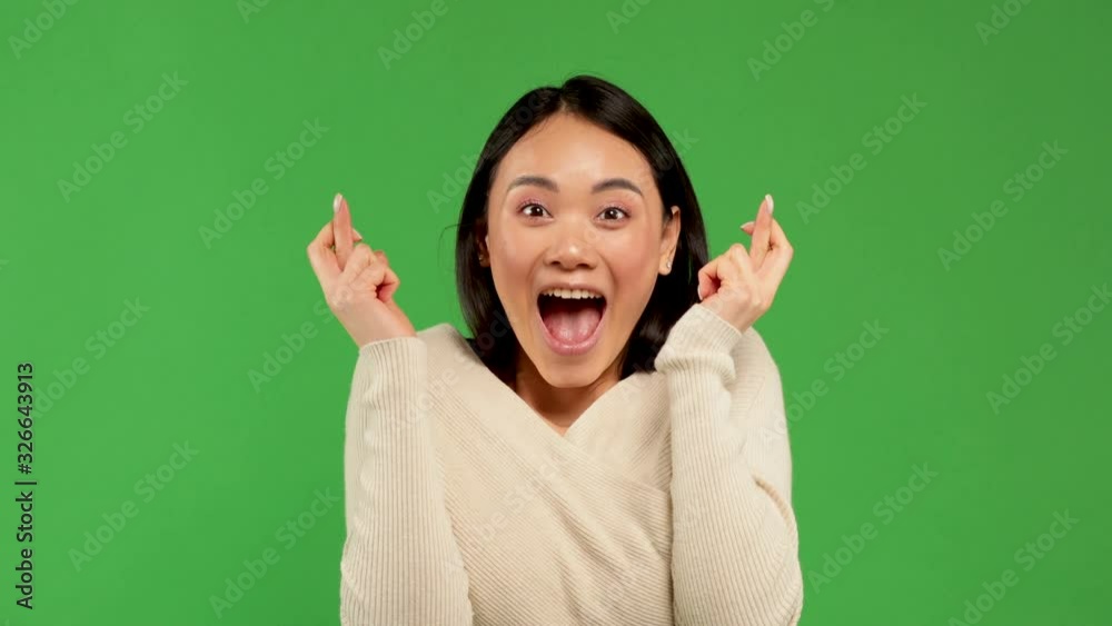 Beautiful african woman crossing her fingers over white background.