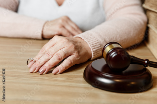 Hands of wife, husband signing decree of divorce, dissolution, canceling marriage, legal separation documents, filing divorce papers or premarital agreement prepared by lawyer.