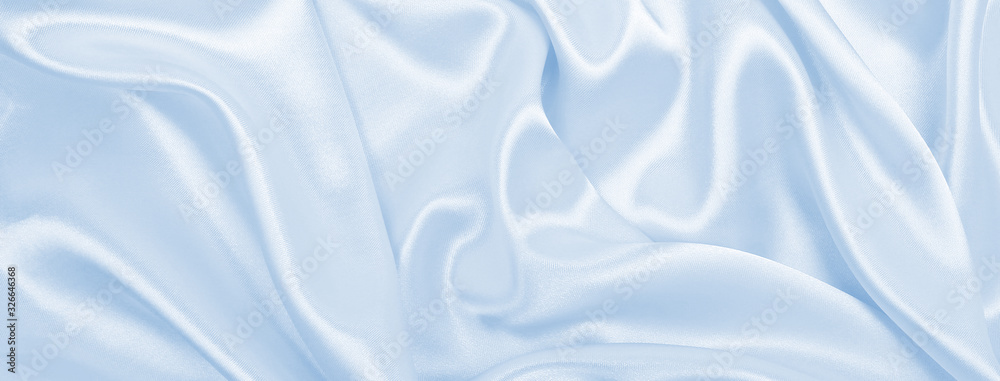 Smooth elegant blue silk or satin luxury cloth texture as abstract background. Luxurious background design Smooth elegant blue silk or satin luxury cloth texture as abstract background. Luxurious background design
