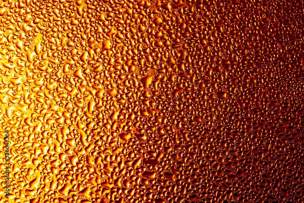 Drops of water on a glass in the golden rays of the sun. Drops of water on a glass in the golden rays of the sun.