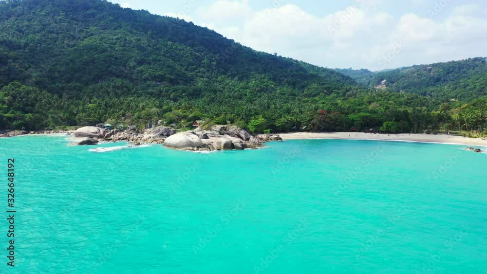 Beaurtiful peaceful blue lagoon,rocky coast and hidden sandy beaches surrounded by rainforest and mountains Beaurtiful peaceful blue lagoon,rocky coast and hidden sandy beaches surrounded by rainforest and mountains