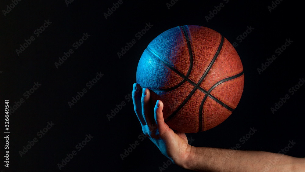 Front view of basketball held by male hand