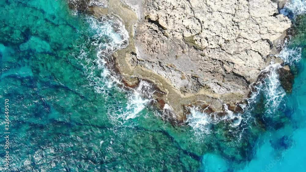 Drone view of blue azure water of sea in Cyprus, waves and island background Drone view of blue azure water of sea in Cyprus, waves and island background