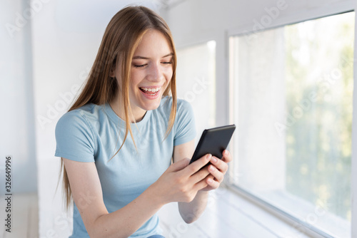 Free Download Happy woman checking her phone - GFXLoad