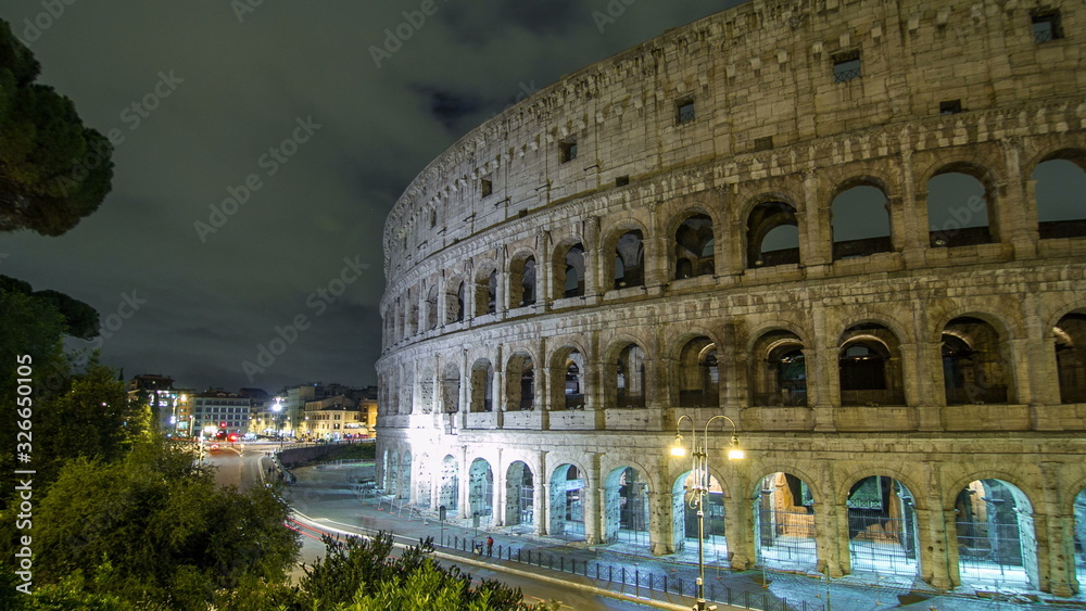 view of Colosseum illuminated at night timelapse  in Rome, Italy