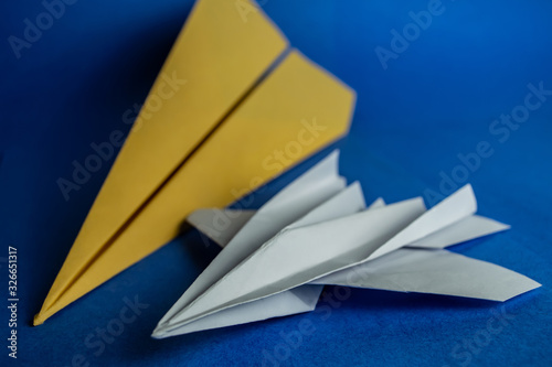 Two paper planes on a blue background