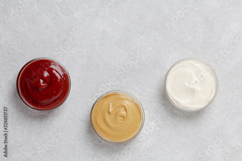 Set of sauces - mustard, ketchup, mayonnaise. Top view. 