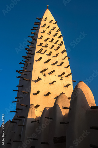 Walls and tower of the Mosque of Bobo-Dioulasso building exterior at sunset, landmark of Burkina Faso, West Africa. photo