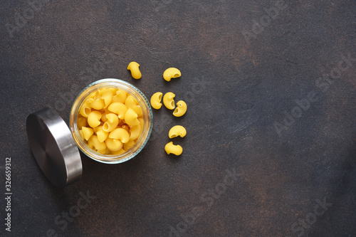 Pasta in a plate on a concrete dark background. Top view copy space. photo