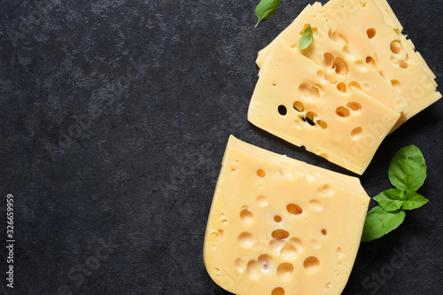 Radamer cheese on a black concrete background. View from above.