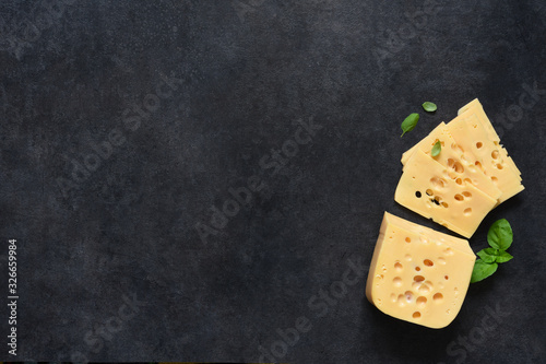 Radamer cheese on a black concrete background. View from above.