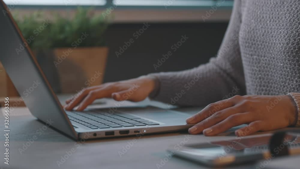 Woman opening her laptop and starting her work