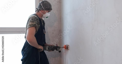 Wallpaper Mural Professional builder drill recess in brick wall under wall outlet, deep hole, perforator, red dust, repairs, redevelopment, electrical network in apartment, drilling walls, worker at construction site Torontodigital.ca