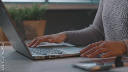 Woman opening her laptop and starting her work