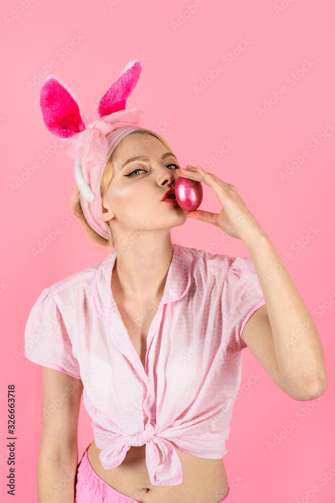 Happy Easter. Hunt for Easter eggs. Hunting eggs. Blonde girl kiss color egg. Spring holiday. Smiling woman with rabbit bunny ears. Happy woman preparing for Easter. Easter celebration.