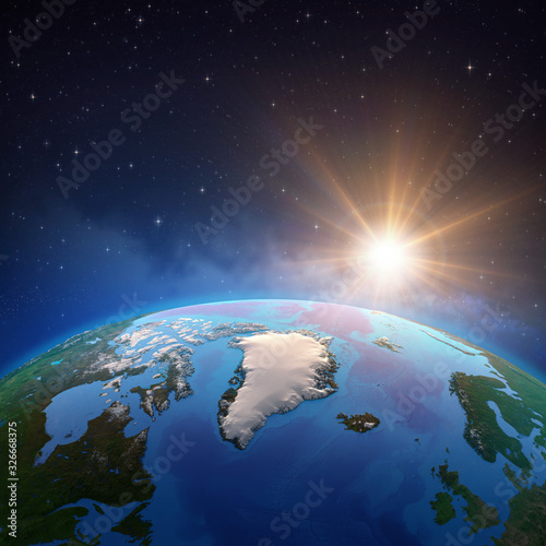 Fototapeta Naklejka Na Ścianę i Meble -  Sun shining over Artic and Greenland from space
