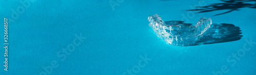 Obraz na płótnie Invisible aligners teeth brackets on blue background w salonie
