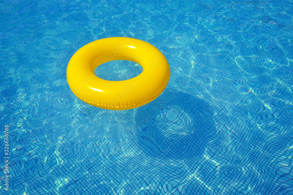 Fototapeta premium Colorful inflatable tube floating in swimming pool