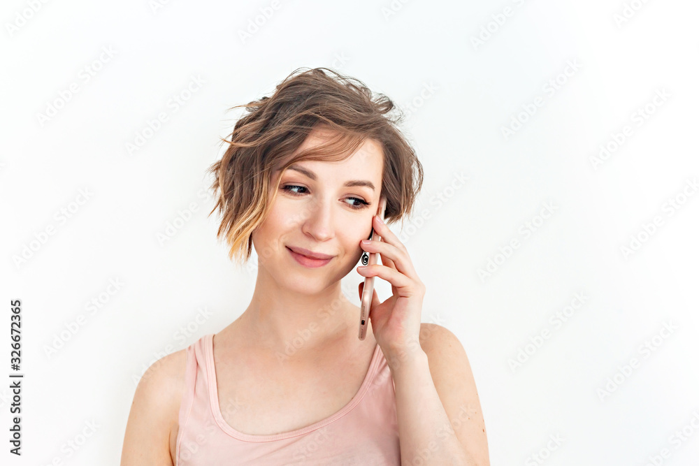 Close up Young Woman Talking to Someone on her Mobile Phone While Looking Into the Distance with Happy Facial Expression on white background Close up Young Woman Talking to Someone on her Mobile Phone While Looking Into the Distance with Happy Facial Expression on white background