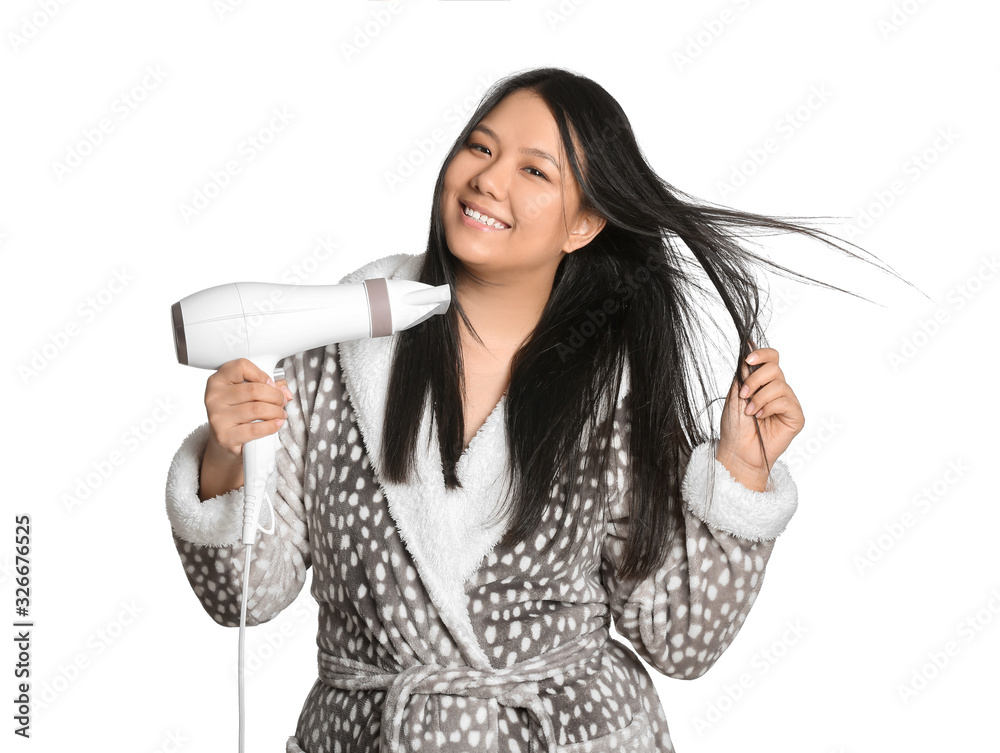 Beautiful Asian woman with hair dryer on white background Beautiful Asian woman with hair dryer on white background