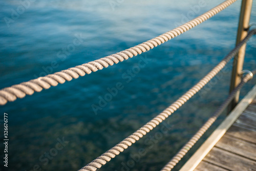 Fotografie, Obraz Close up of rope fence on wooden pier