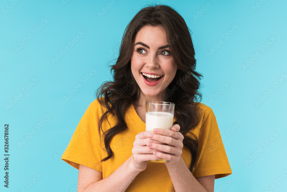 Positive optimistic young beautiful woman holding milk. Positive optimistic young beautiful woman holding milk.