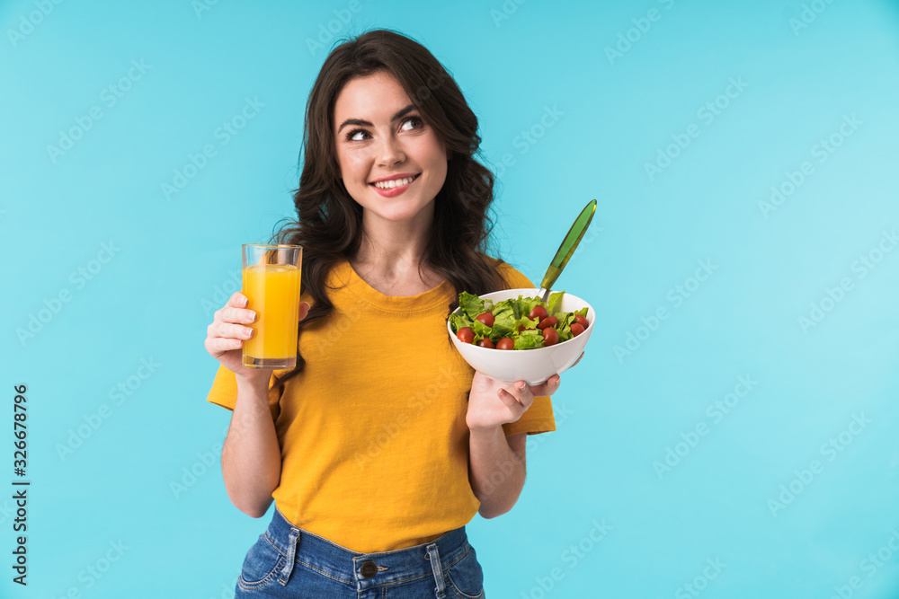 Woman posing isolated holding salad and juice. Woman posing isolated holding salad and juice.