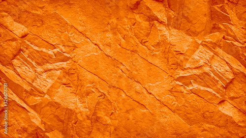 Red orange grunge background. Toned stone texture. Mountain texture close-up. lush lava color trend 2020. Bright colorful rock texture banner for your design.