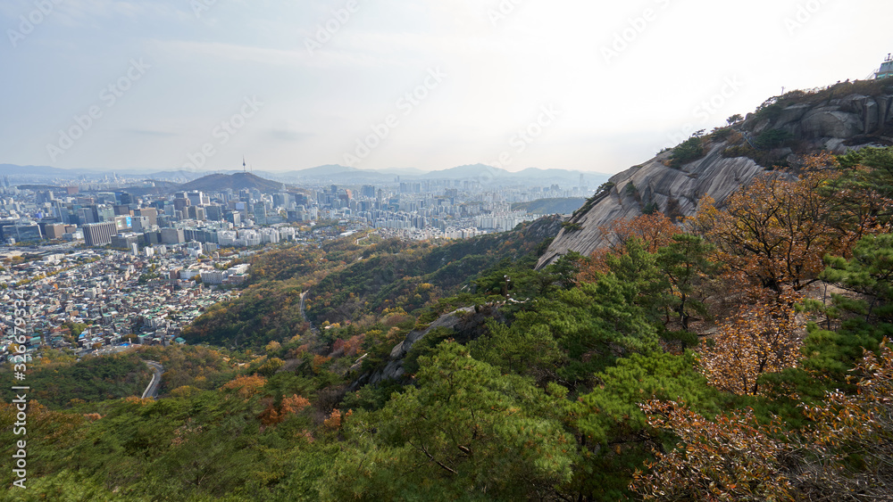 Aerial panorama of the Seoul with N Tower on the top of Namsan Mountain and downtown in South Korea from the top of Inwangsan mountain. 