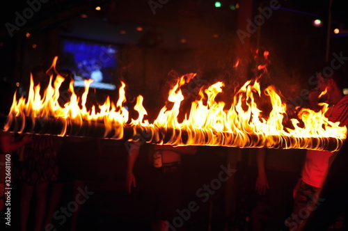 Fire show performance at a beachfront restaurant in Thailand tourist attraction