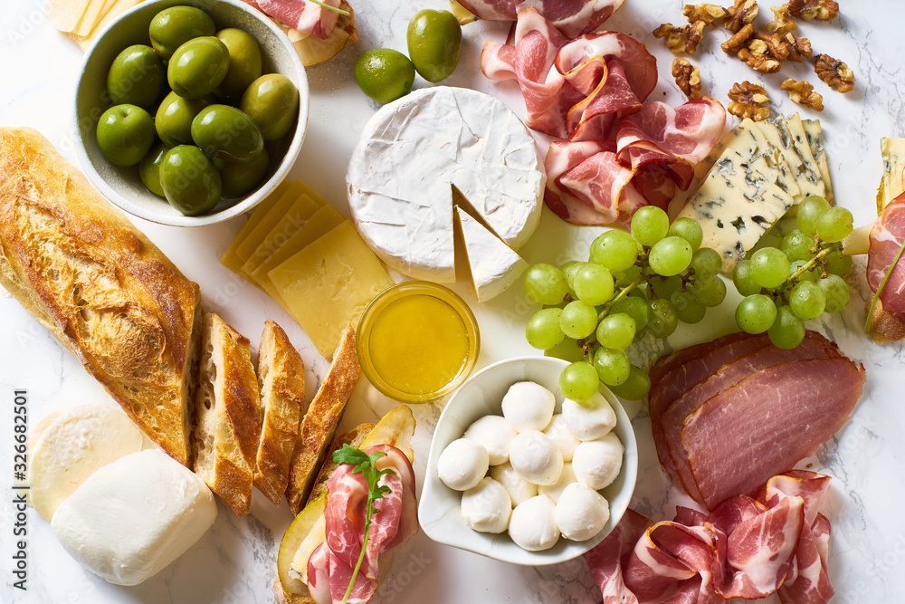 Big plate of appetizers for party of breakfast. Set of gourmet cheese and meat. Overhead view