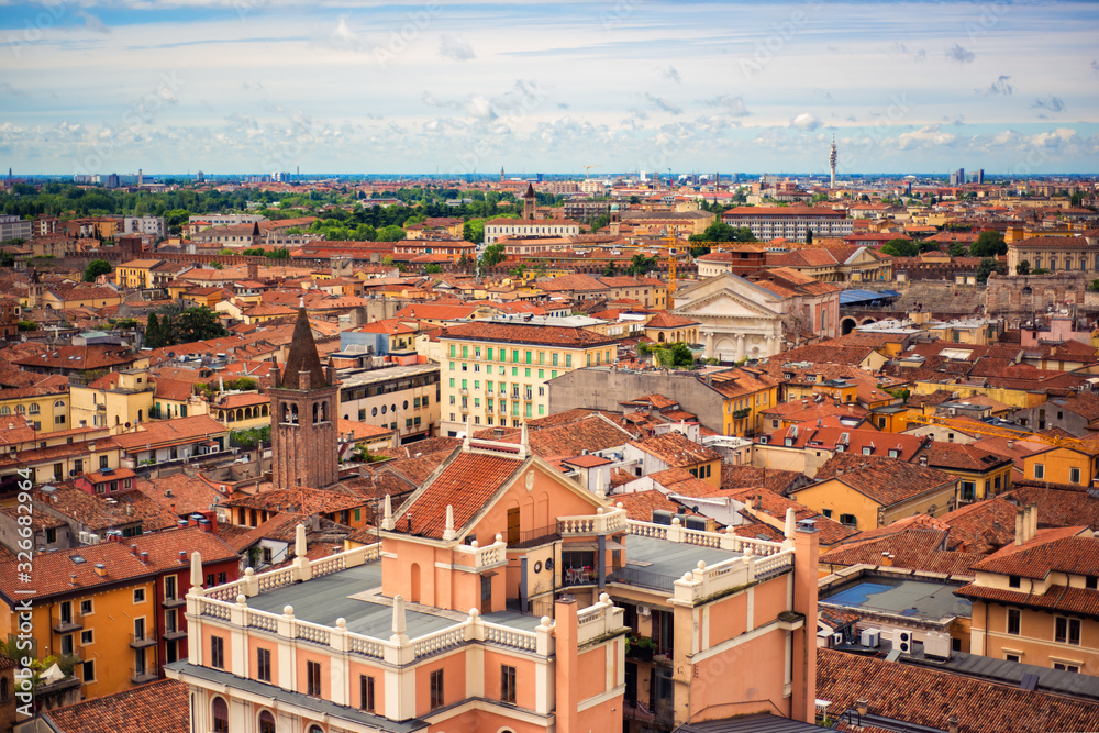 View on roofs of most romantic city of Italy Verona, Veneto. Blue sky above red roofs of medieval city. Spring in italian city. City landscape of italian Verona. Travel tourism destination in Italy