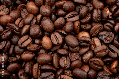 Energy stimulant and smooth java concept with full frame photograph of piled roasting coffee beans backgrounds