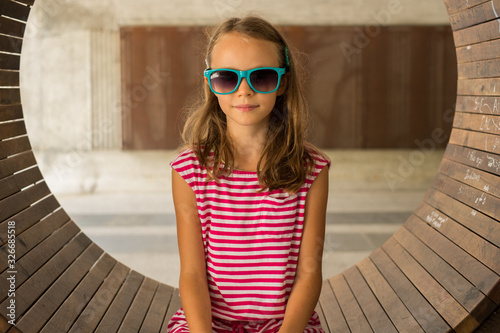 Girl Sitting and posing for a photo during summer vacations