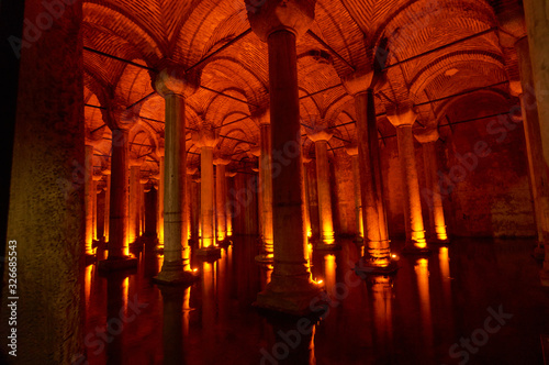 Stone columns backlit in red in the Yerebatan cistern in Istanbul, Turkey.