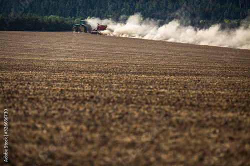 Tractor plowing a dry farm field